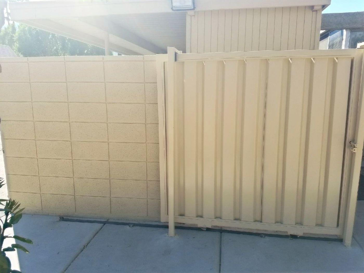 New fence installation beside a concrete walkway