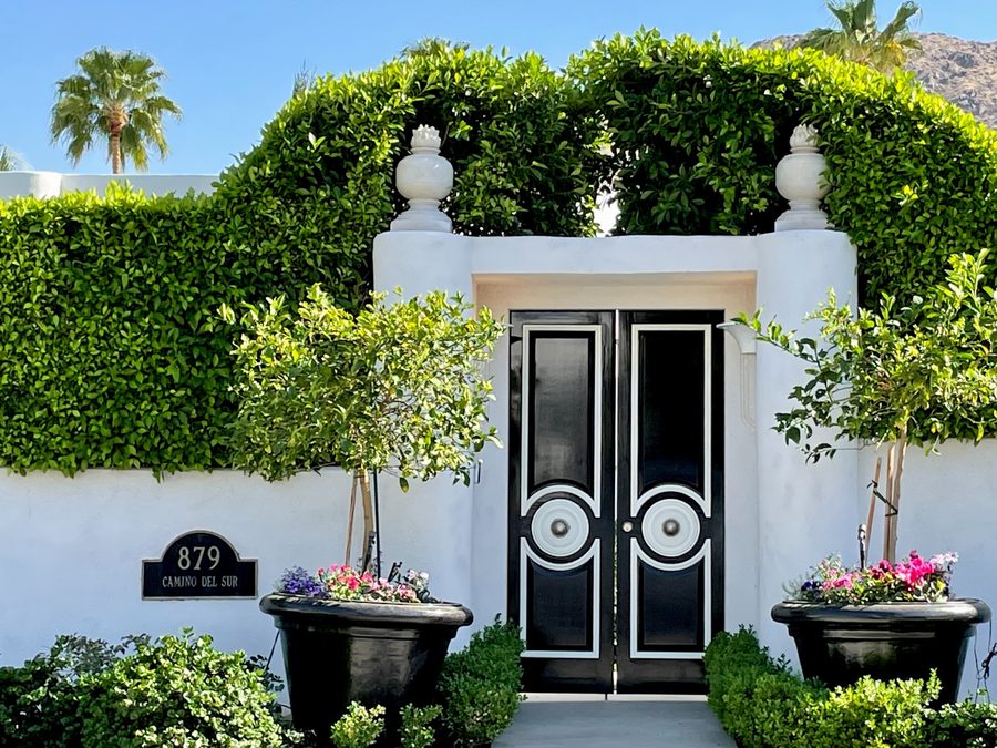 Custom wrought iron gate entry with landscaping