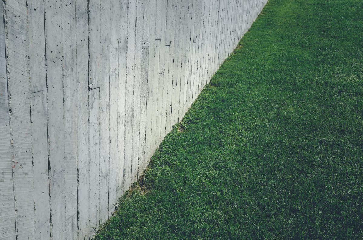 Lawn beside a concrete retaining wall